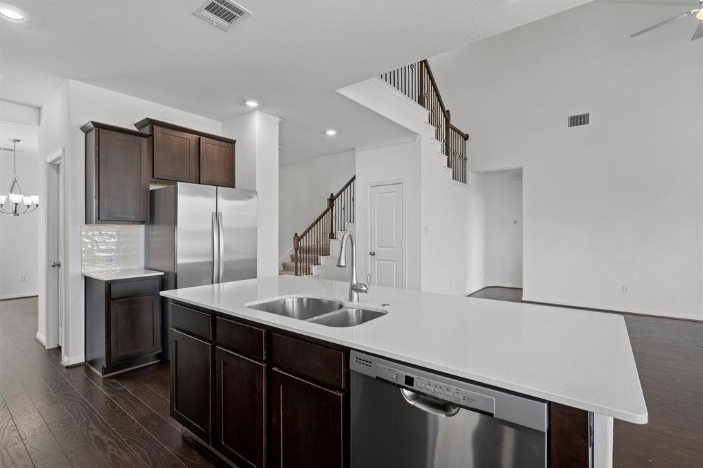 236 Prato Place Georgetown, TX 78628 - Photo 14 of 40 A well-appointed kitchen island with gleaming counters anchors this open-concept living space.