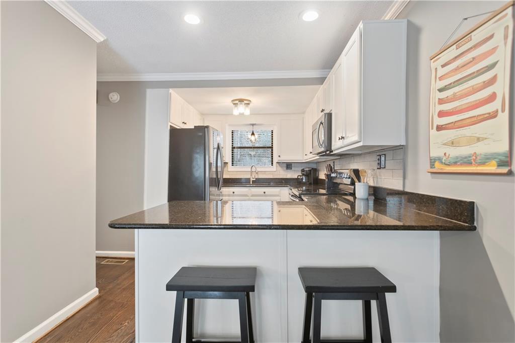 641 Riverside Drive Ellijay, GA 30540 - Photo 13 of 42 a kitchen with stainless steel appliances granite countertop a sink a stove and a refrigerator