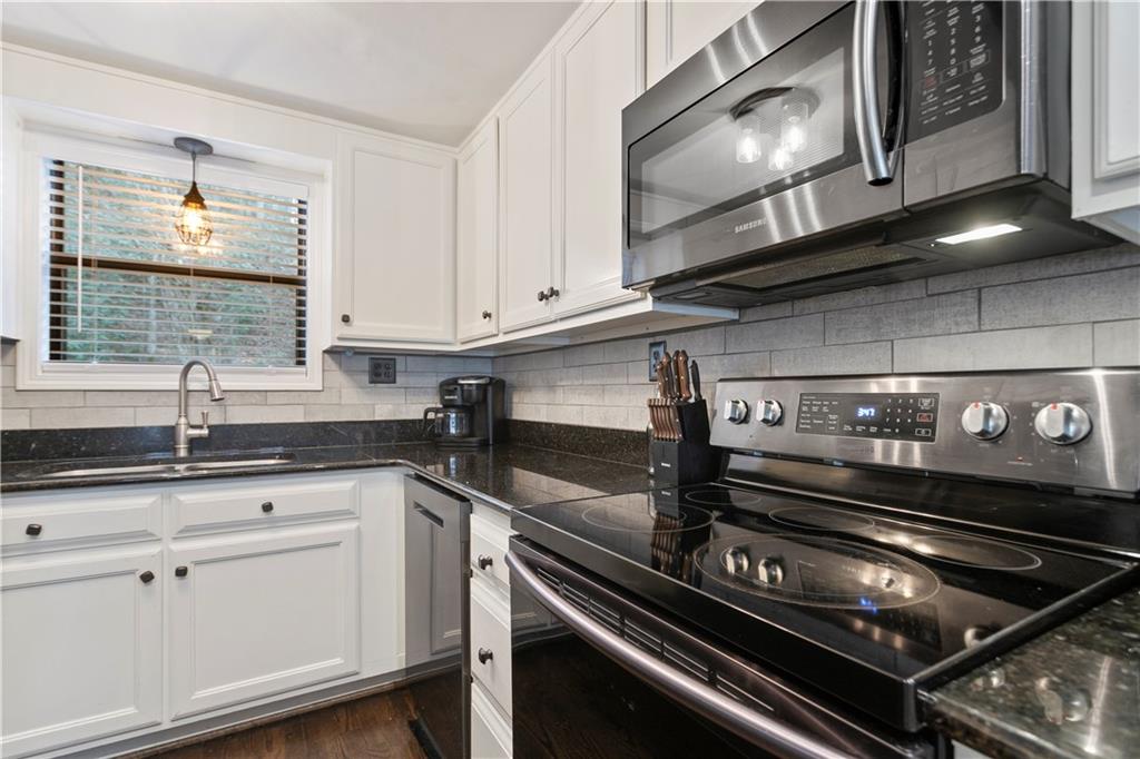 641 Riverside Drive Ellijay, GA 30540 - Photo 15 of 42 a kitchen with granite countertop a stove microwave and sink