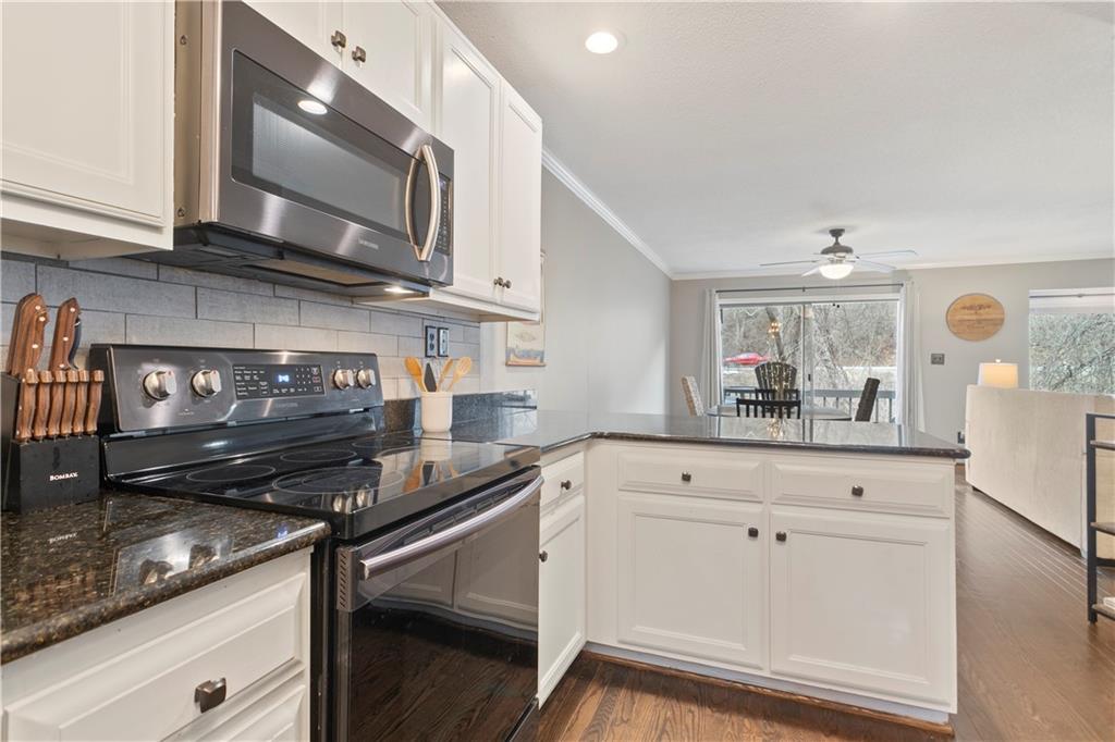 641 Riverside Drive Ellijay, GA 30540 - Photo 16 of 42 a kitchen with stainless steel appliances granite countertop a sink stove and cabinets