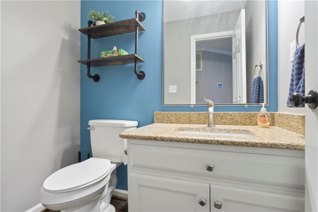 641 Riverside Drive Ellijay, GA 30540 - Photo 18 of 42 a bathroom with a granite countertop toilet sink and mirror