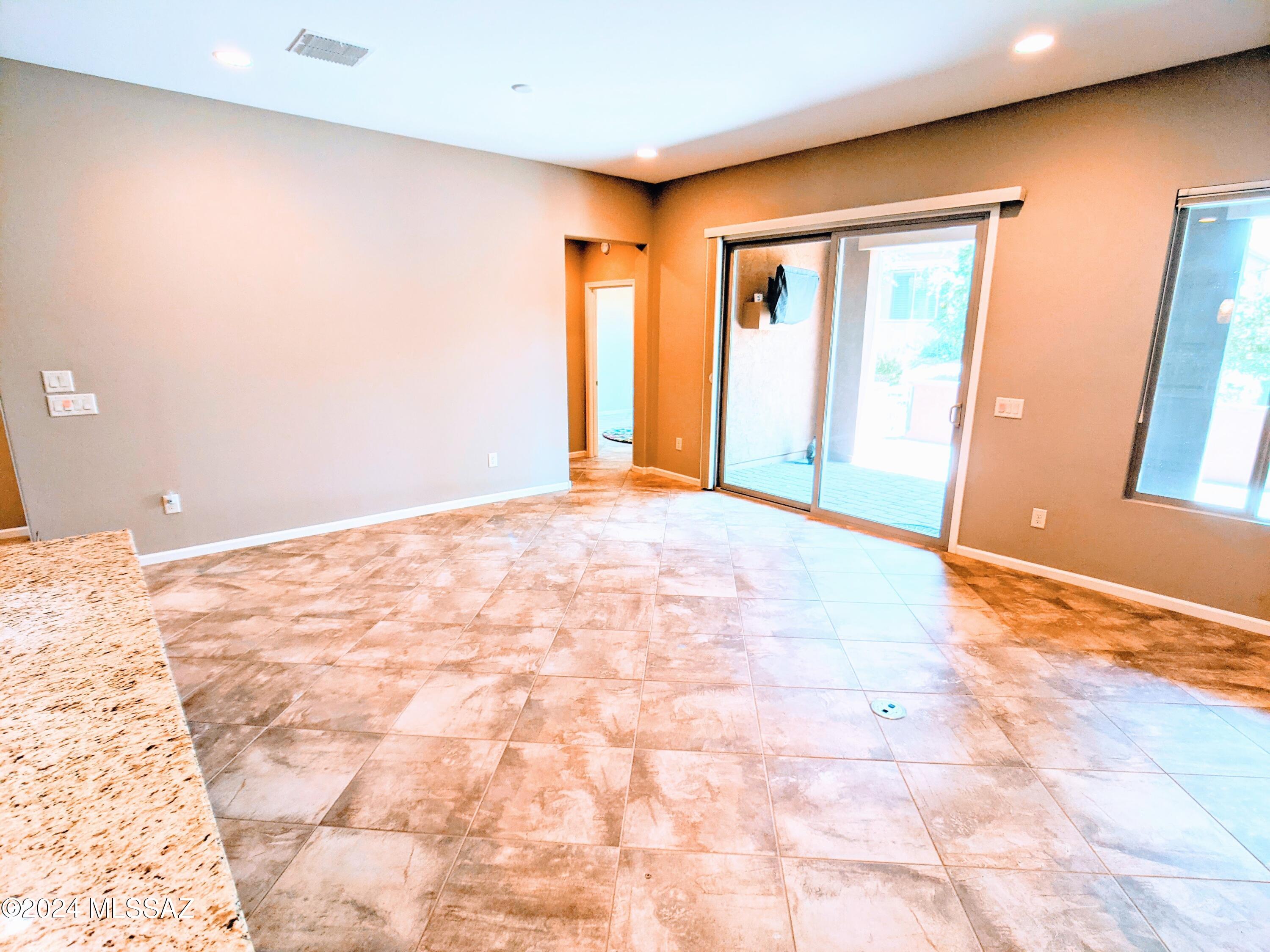 61021 East Slate Road Oracle, AZ 85623 - Photo 3 of 18 a view of an empty room with window and wooden floor