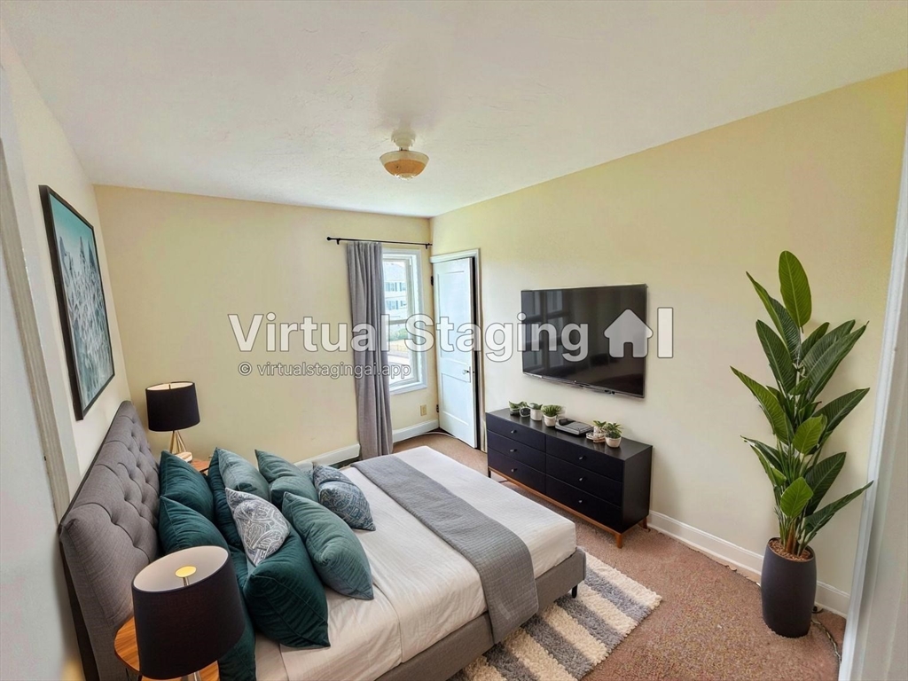 528 Lawton Street, Unit 2 Fall River, MA 02721 - Photo 15 of 20 a bedroom with furniture and a potted plant