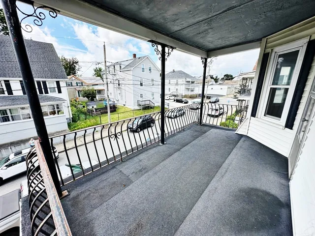 a view of a porch with wooden floor and furniture