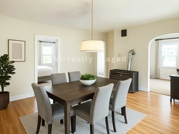 a view of a dining room with furniture and wooden floor