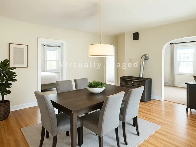 a view of a dining room with furniture and wooden floor
