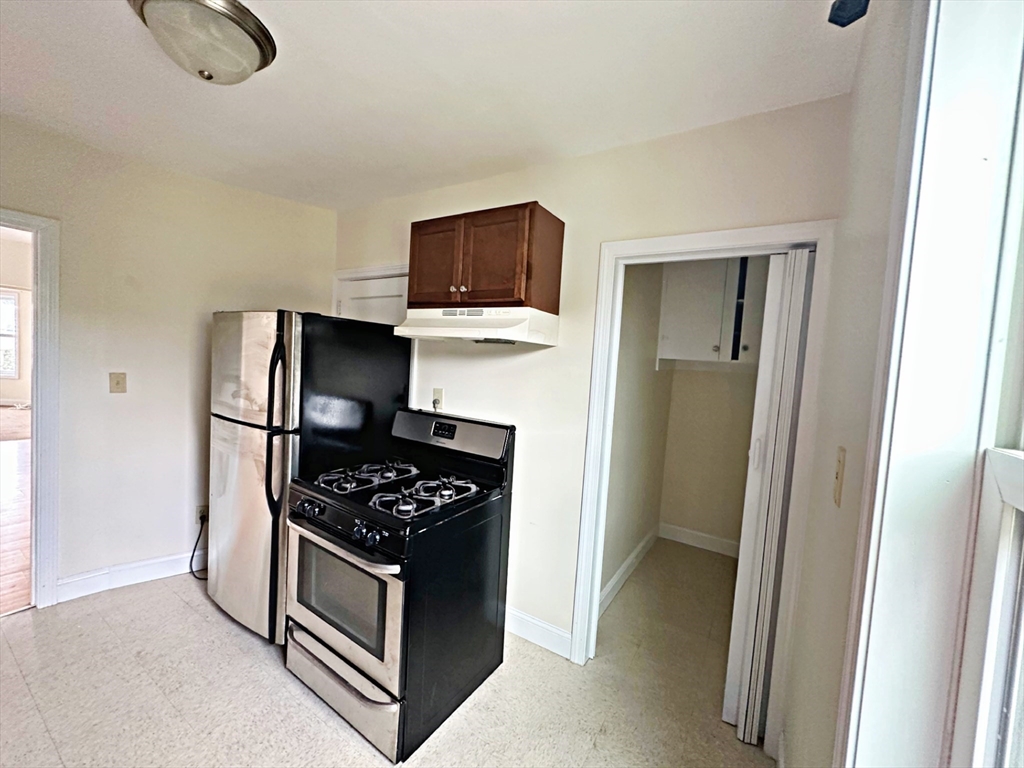 528 Lawton Street, Unit 2 Fall River, MA 02721 - Photo 8 of 20 a kitchen with stainless steel appliances a refrigerator and a stove top oven