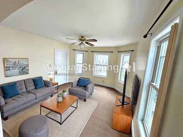 a living room with furniture and a window
