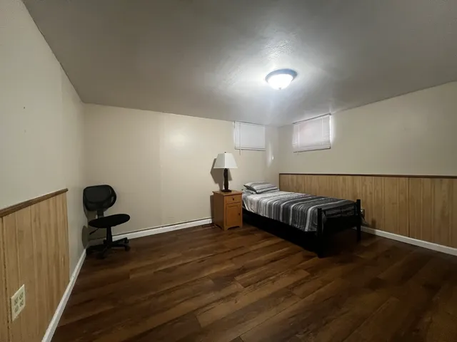 a bedroom with a bed and a chair