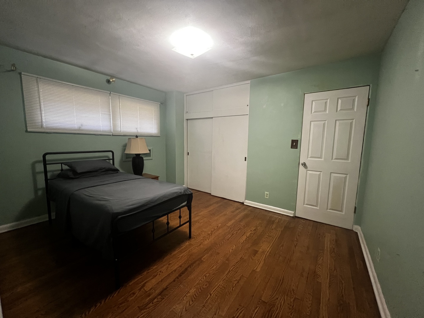 1930 23rd Street Zion, IL 60099 - Photo 8 of 18 a bedroom with a bed and wooden floor