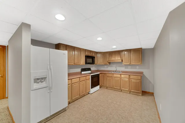 a kitchen with white cabinets and white appliances