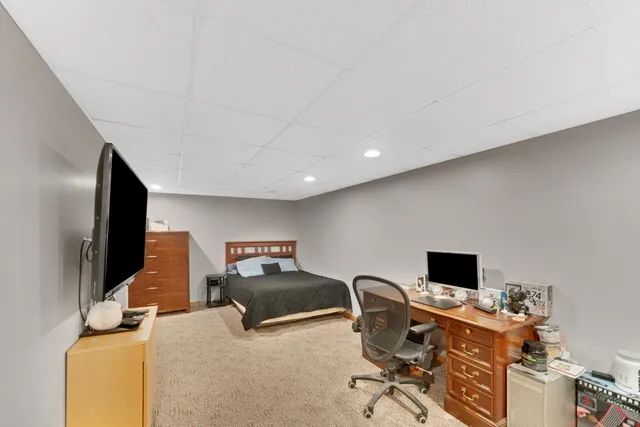 a view of a workspace with furniture and a flat screen tv