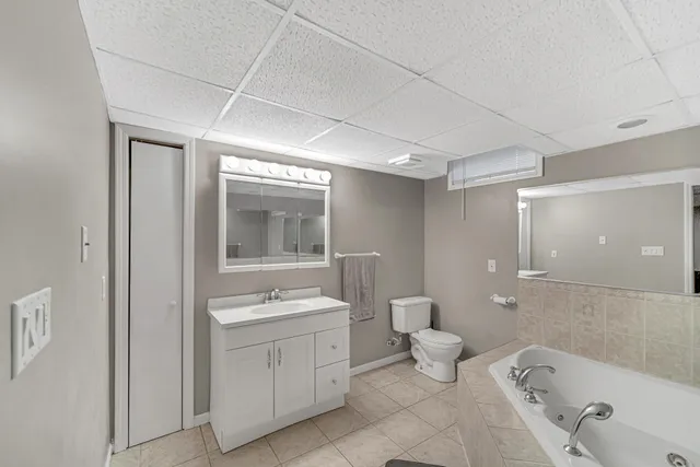 a bathroom with a toilet sink and mirror