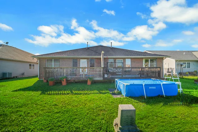a view of a house with a backyard and a patio