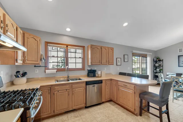 a kitchen that has a sink and a stove in it