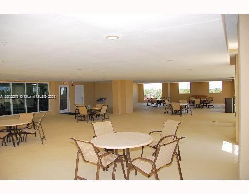 117 Northwest 42nd Avenue, Unit 1609 Miami, FL 33126 - Photo 15 of 15 a dining room with furniture and a floor to ceiling window