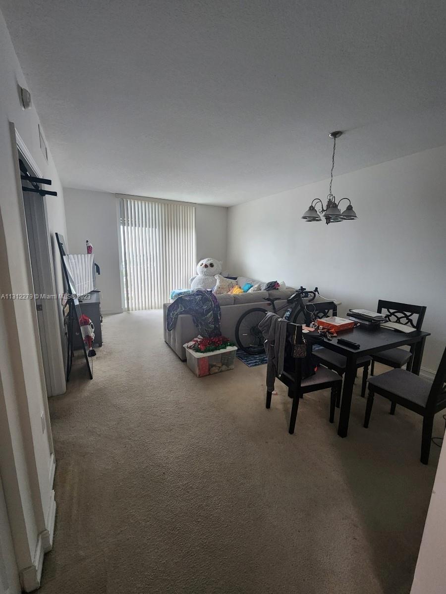 117 Northwest 42nd Avenue, Unit 1609 Miami, FL 33126 - Photo 2 of 15 a living room with furniture and a window
