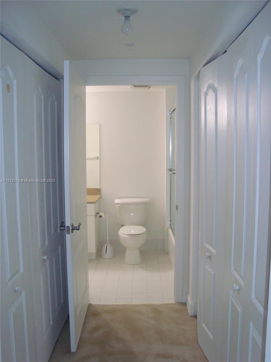 117 Northwest 42nd Avenue, Unit 1609 Miami, FL 33126 - Photo 4 of 15 a bathroom with a granite countertop sink toilet and shower