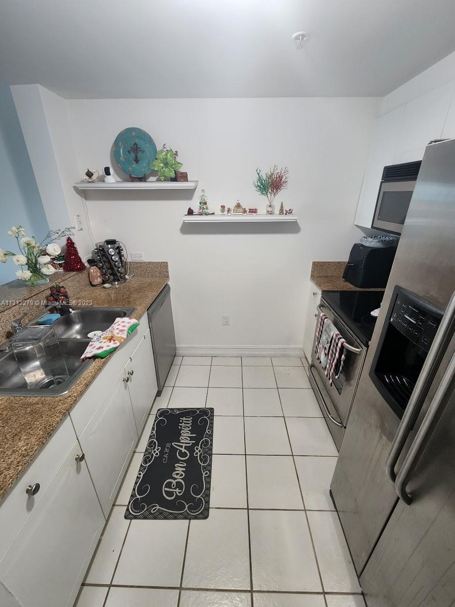 117 Northwest 42nd Avenue, Unit 1609 Miami, FL 33126 - Photo 8 of 15 a storage & utility room with sink dryer and washer