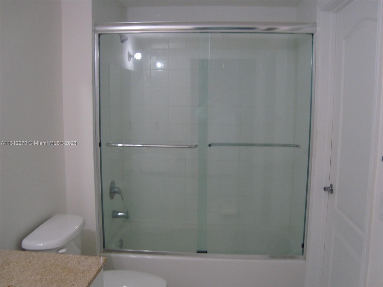117 Northwest 42nd Avenue, Unit 1609 Miami, FL 33126 - Photo 9 of 15 a bathroom with a shower and a toilet