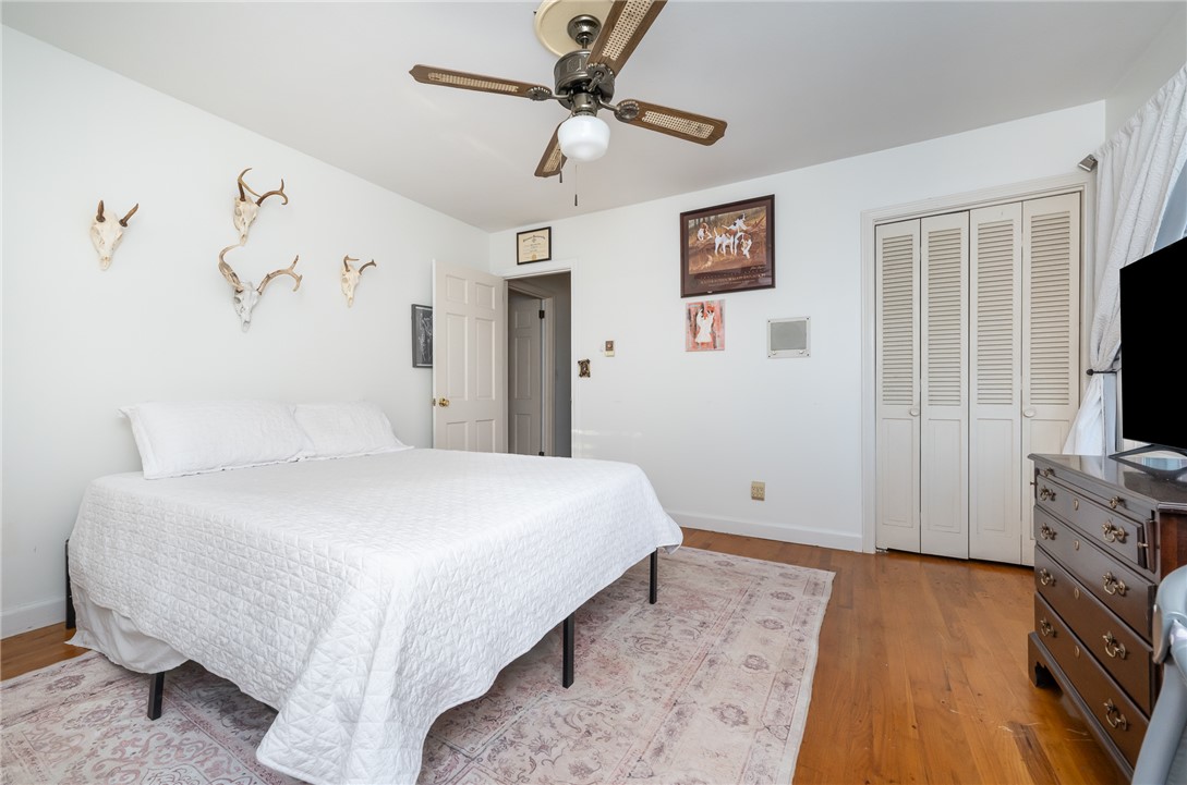 401 South Glassy Mountain Road Pickens, SC 29671 - Photo 11 of 37 This inviting bedroom offers hardwood floors and a ceiling fan, perfect for comfortable living.
