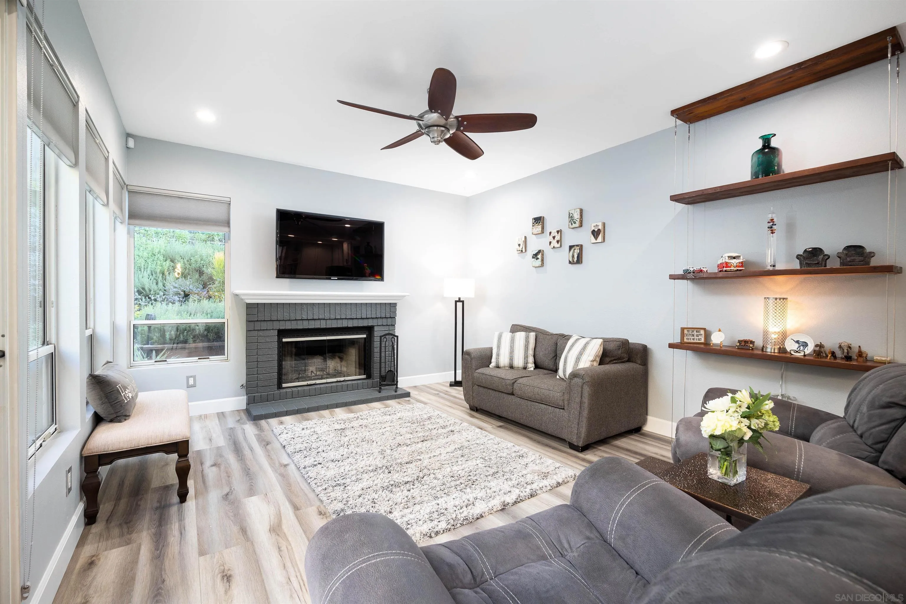 13835 Carmel Ridge Road San Diego, CA 92128 - Photo 12 of 38 a living room with furniture a flat screen tv and a fireplace