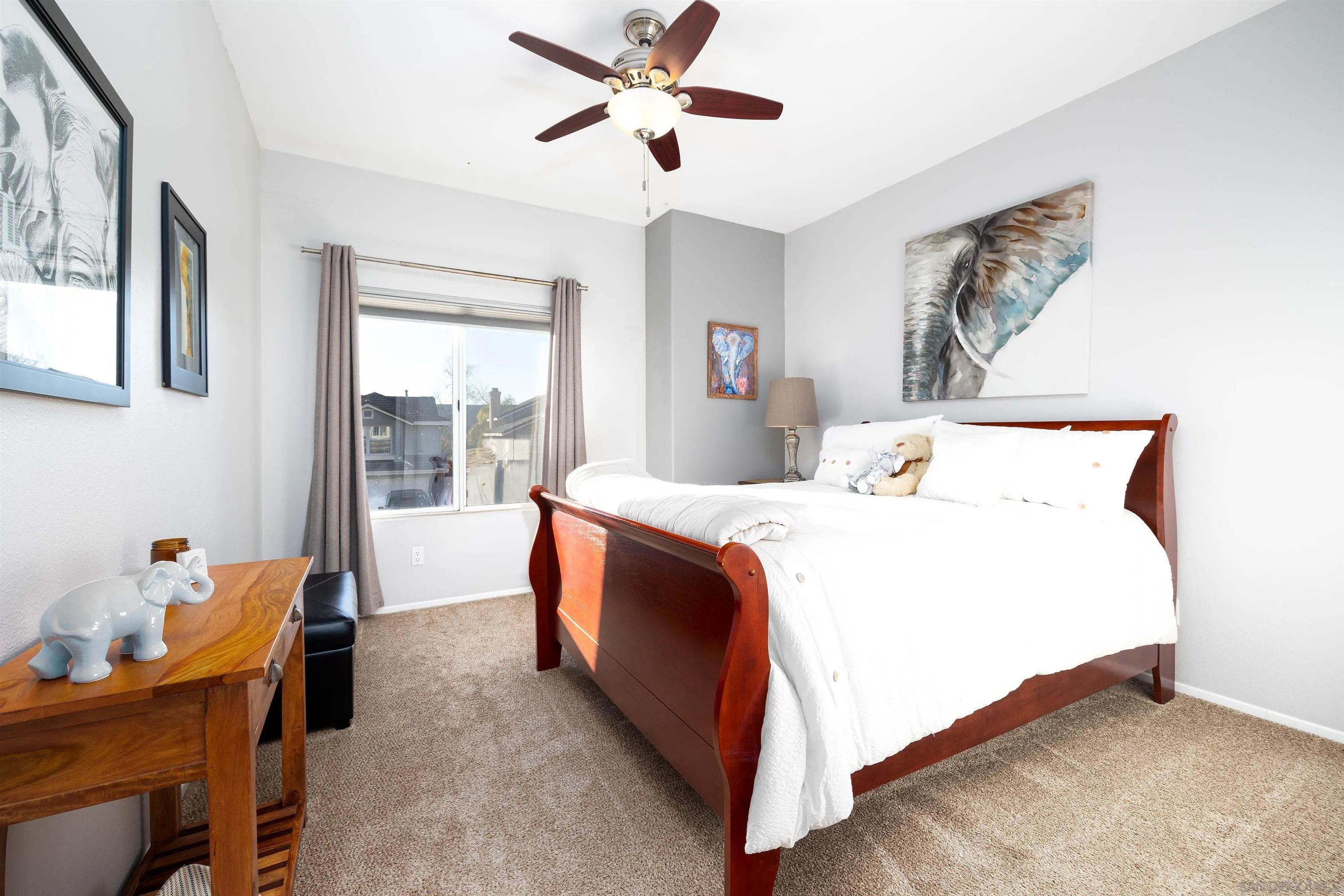 13835 Carmel Ridge Road San Diego, CA 92128 - Photo 19 of 38 a spacious bedroom with a bed and a chandelier