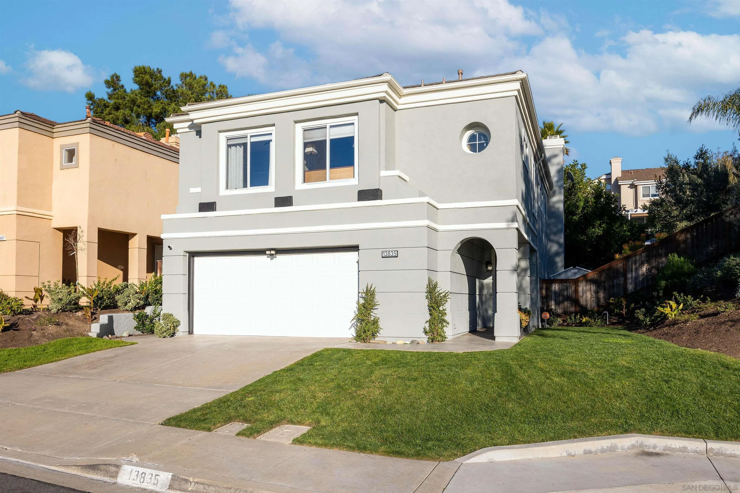 13835 Carmel Ridge Road San Diego, CA 92128 - Photo 2 of 38 a front view of a house with garden