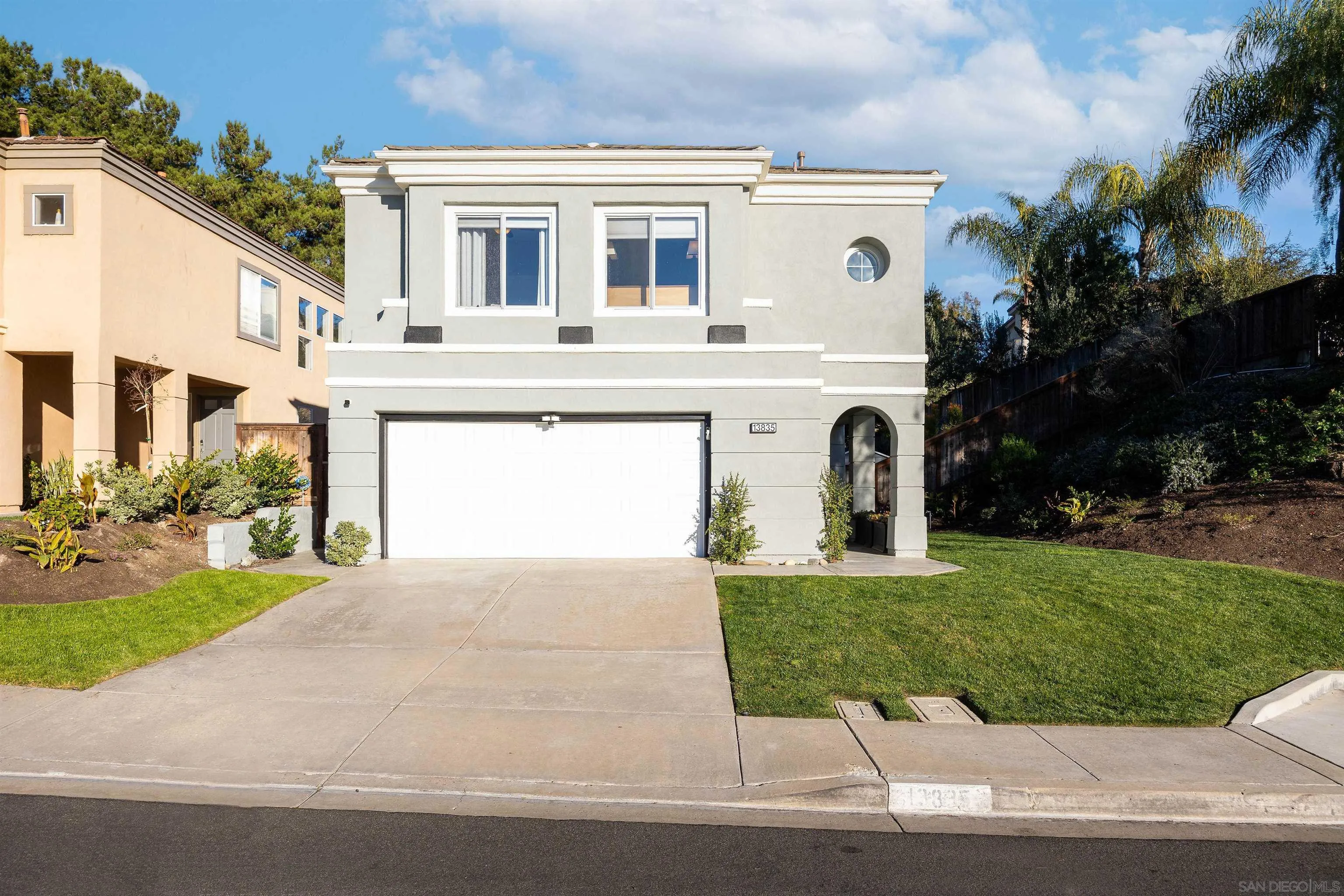 13835 Carmel Ridge Road San Diego, CA 92128 - Photo 3 of 38 a front view of a house with garden