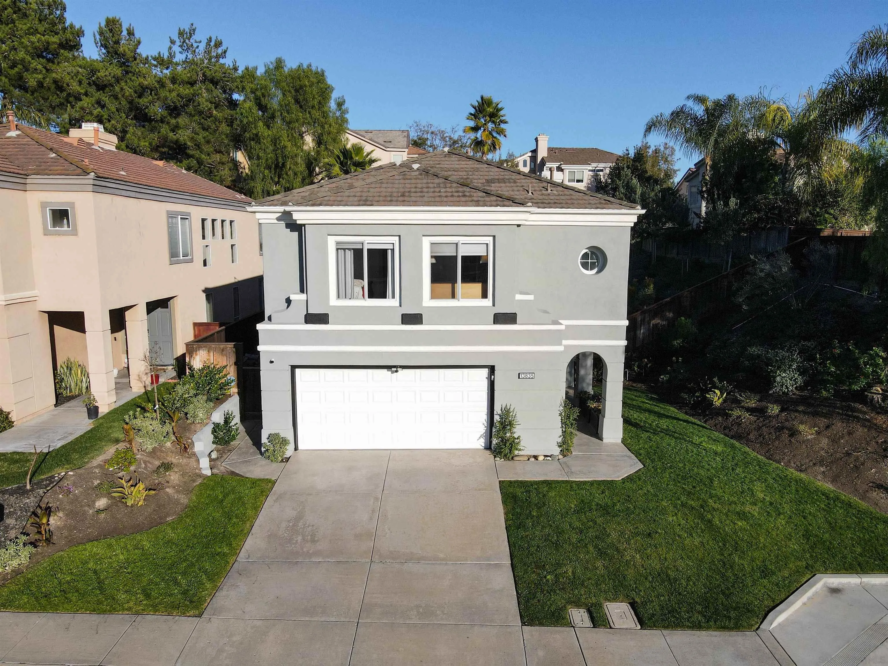 13835 Carmel Ridge Road San Diego, CA 92128 - Photo 31 of 38 a front view of a house with a garden