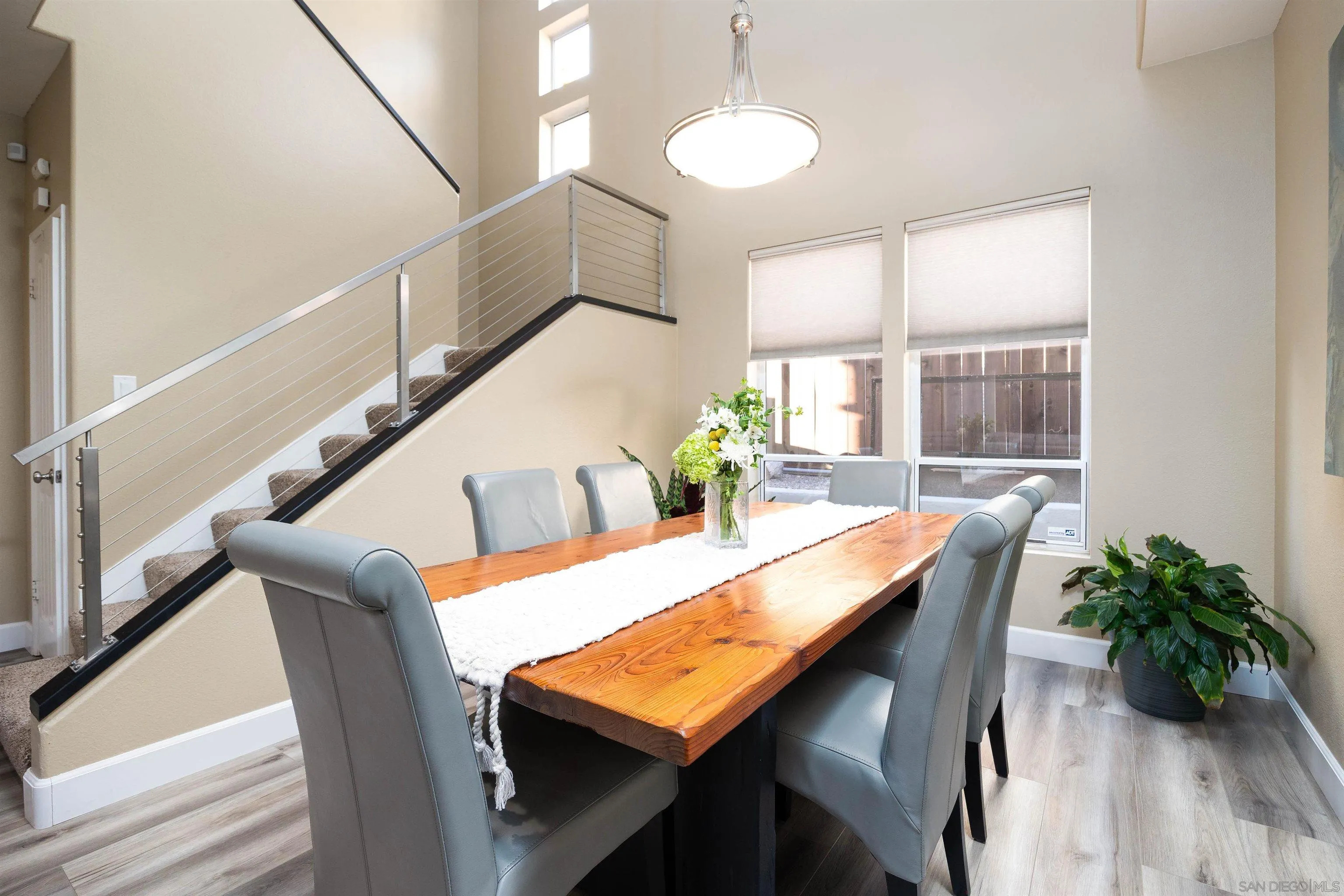 13835 Carmel Ridge Road San Diego, CA 92128 - Photo 7 of 38 a view of a dining room with furniture window and wooden floor