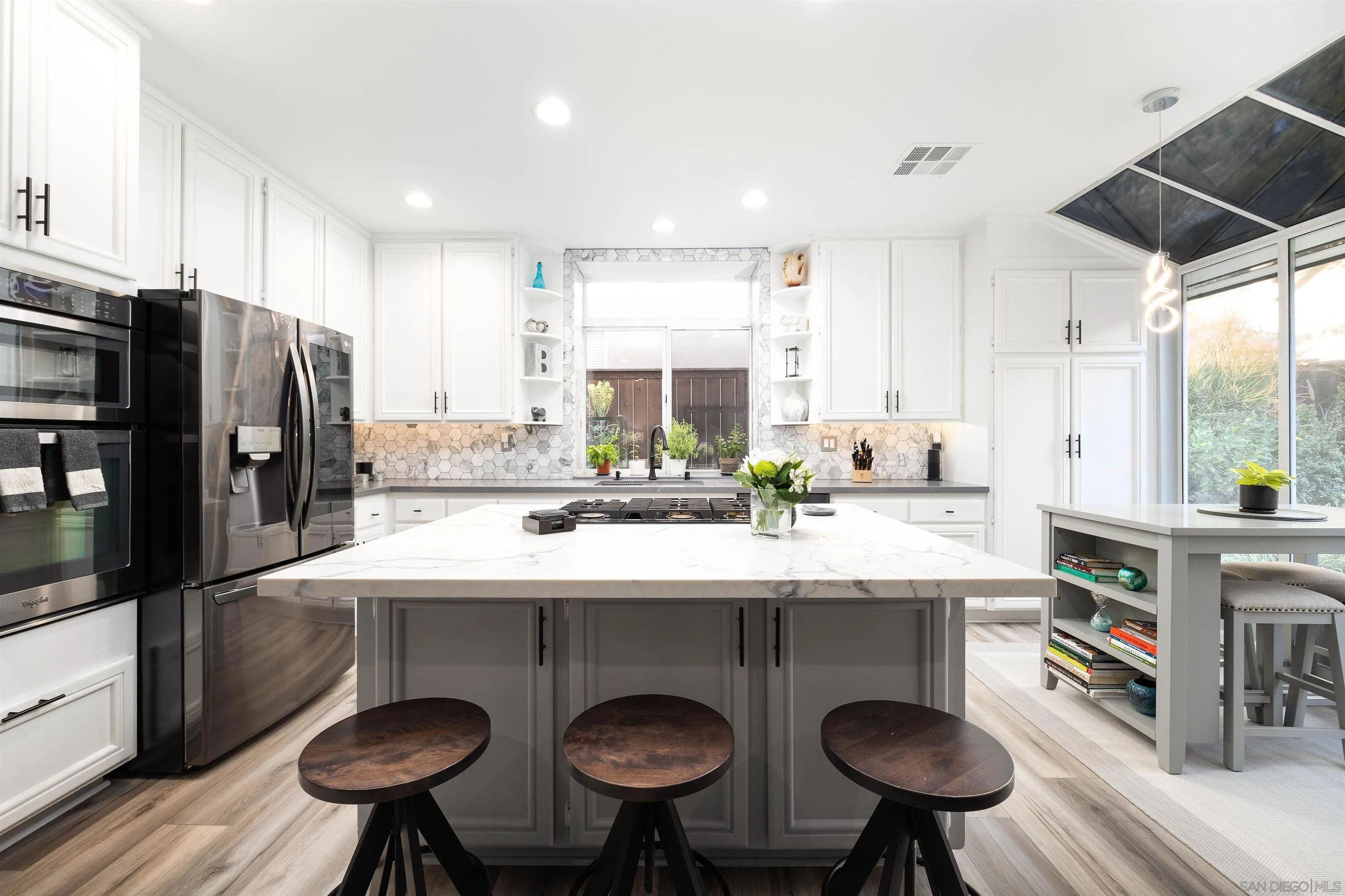 13835 Carmel Ridge Road San Diego, CA 92128 - Photo 8 of 38 a kitchen with stainless steel appliances a sink and a refrigerator