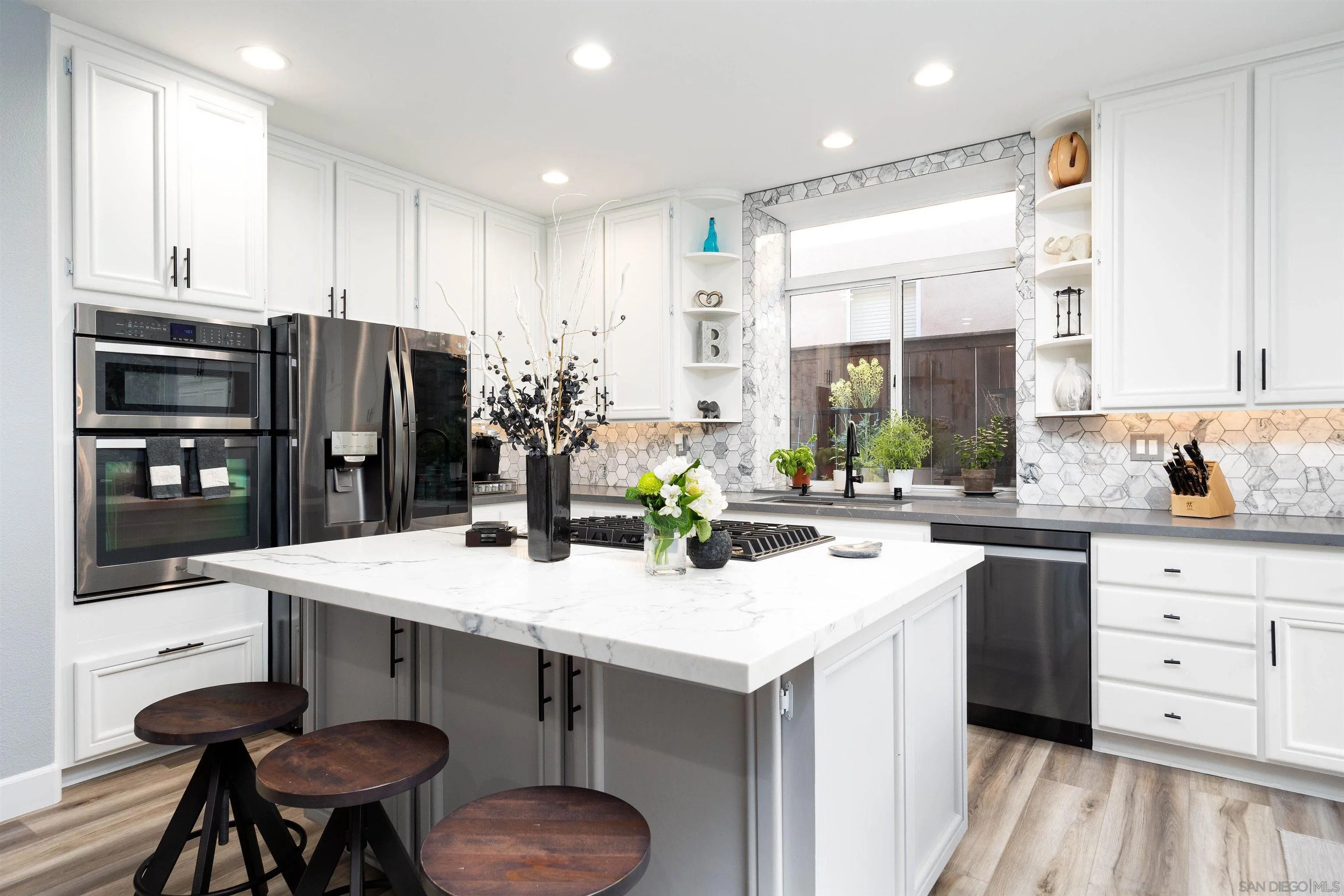13835 Carmel Ridge Road San Diego, CA 92128 - Photo 10 of 38 a kitchen with stainless steel appliances a sink stove and refrigerator