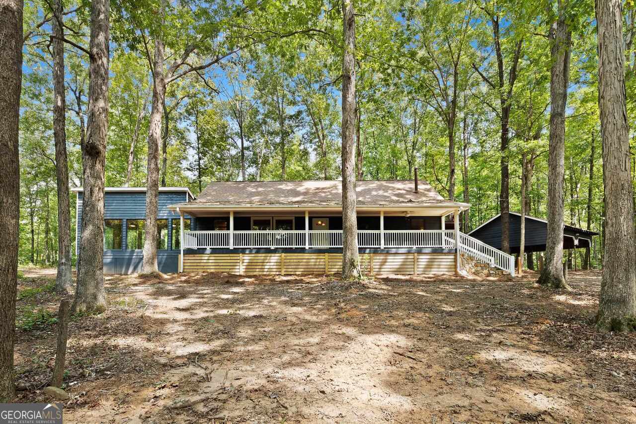 1597 Leguin Mill Road Locust Grove, GA 30248 - Photo 1 of 1 a view of a house with a large window and wooden fence