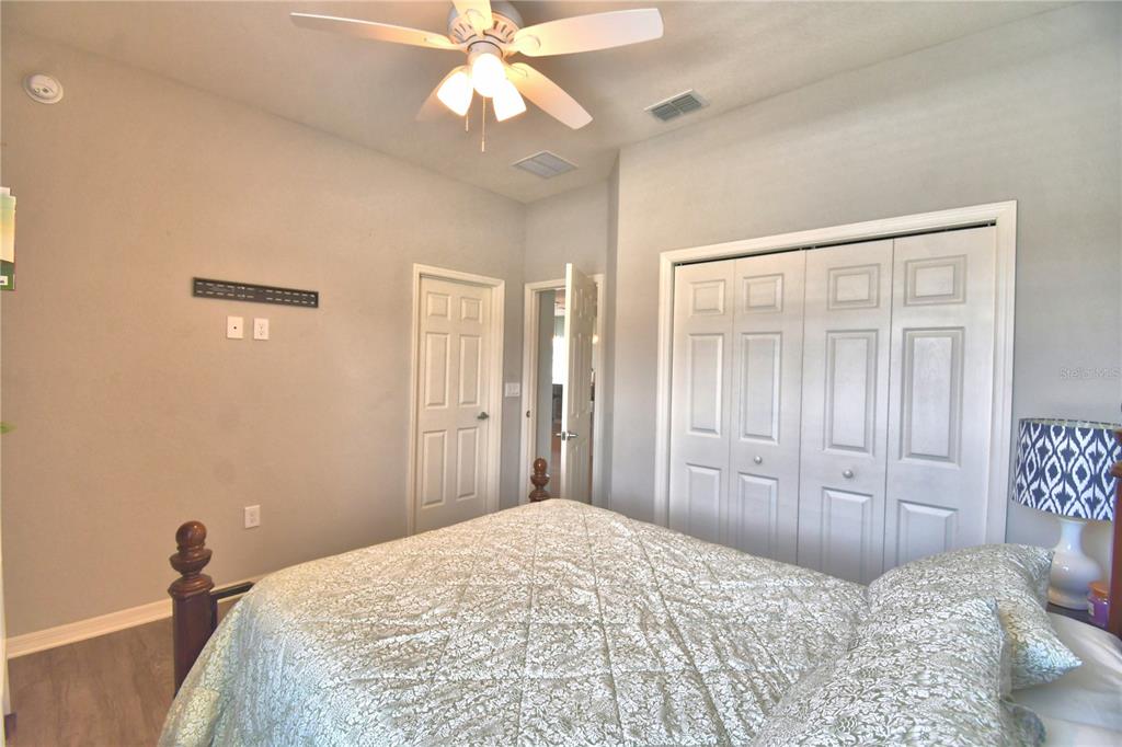 4340 Reding Way Lakeland, FL 33813 - Photo 29 of 63 a bedroom with a large bed and a chandelier