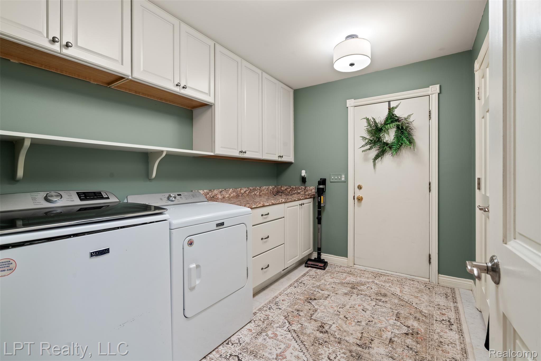 2588 East Jones Road Howell, MI 48855 - Photo 18 of 40 Laundry room featuring washing machine and dryer and cabinet space