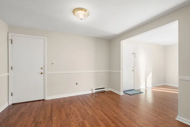 an empty room with wooden floor