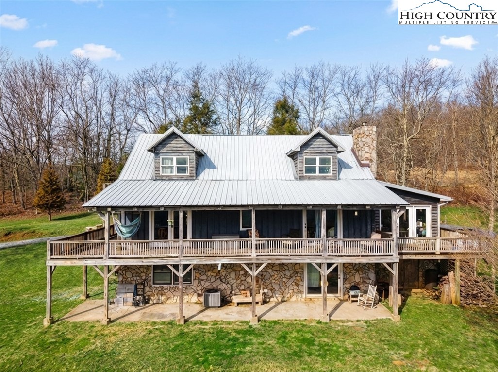 480 Schoolhouse Ridge Boone, NC 28607 - Photo 1 of 47 a aerial view of a house with swimming pool and sitting area