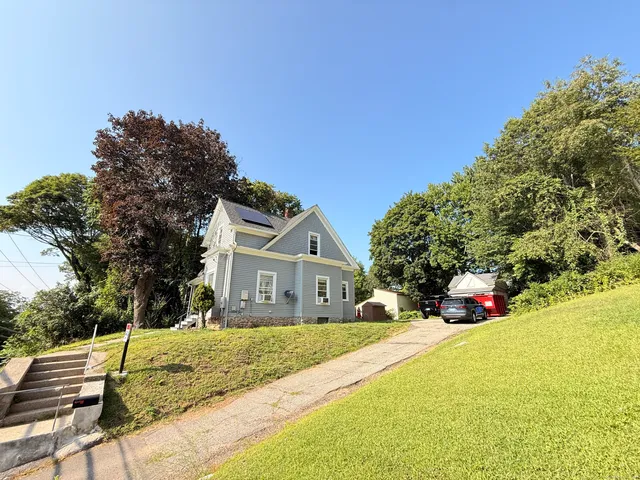 a front view of a house with a yard