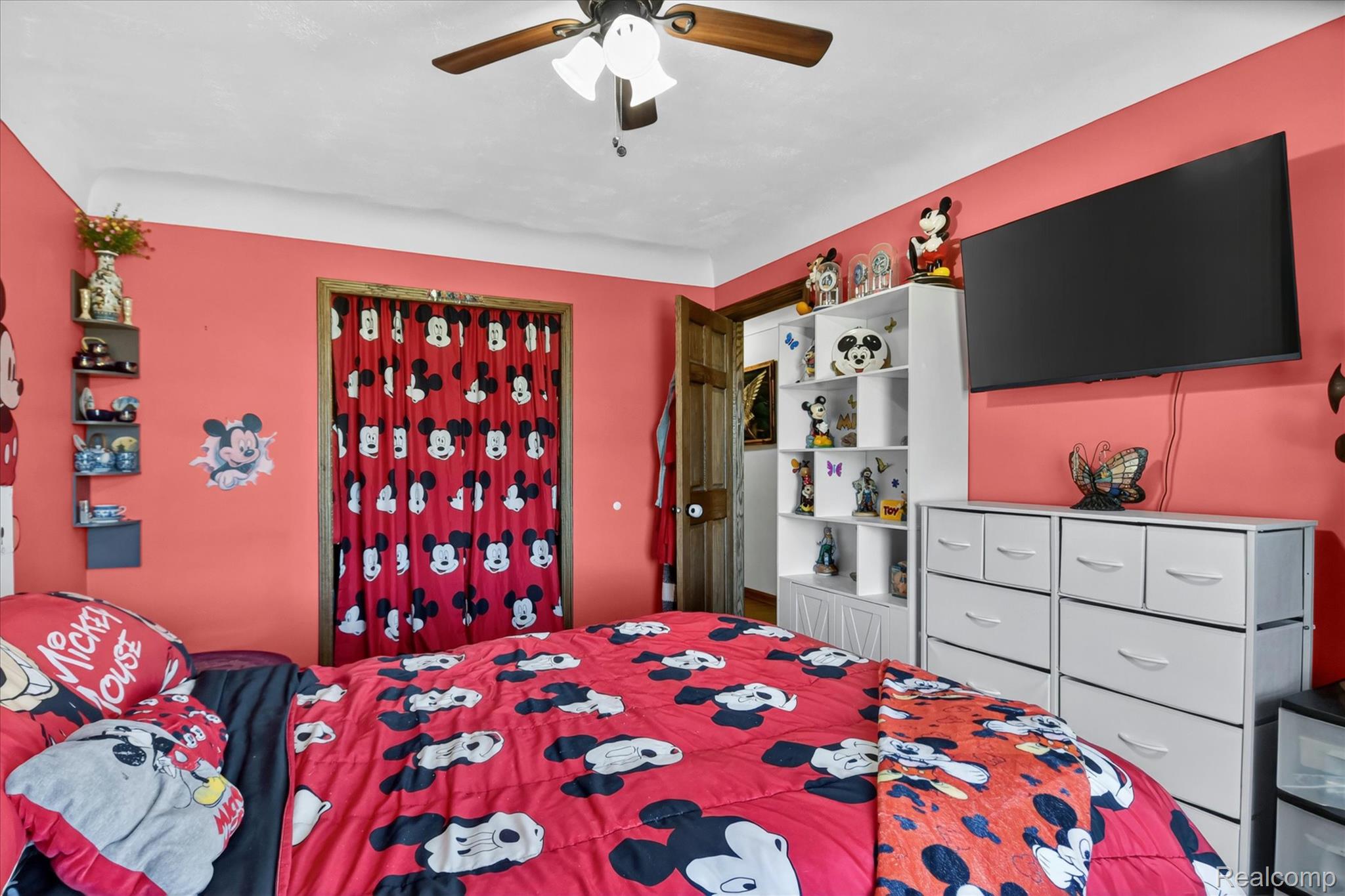 3949 West Burns Line Road Brown City, MI 48416 - Photo 37 of 70 Room featuring a ceiling fan, crown molding, and a built-in shelving unit