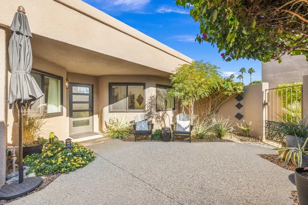 a bathroom with a sink a toilet a mirror and shower