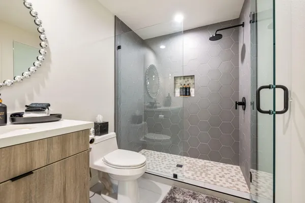 a living room with furniture a chandelier and a flat screen tv