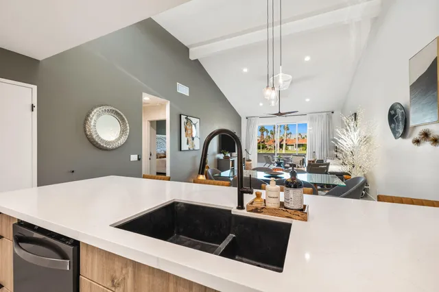 a bedroom with a bed a flat screen tv and a couch