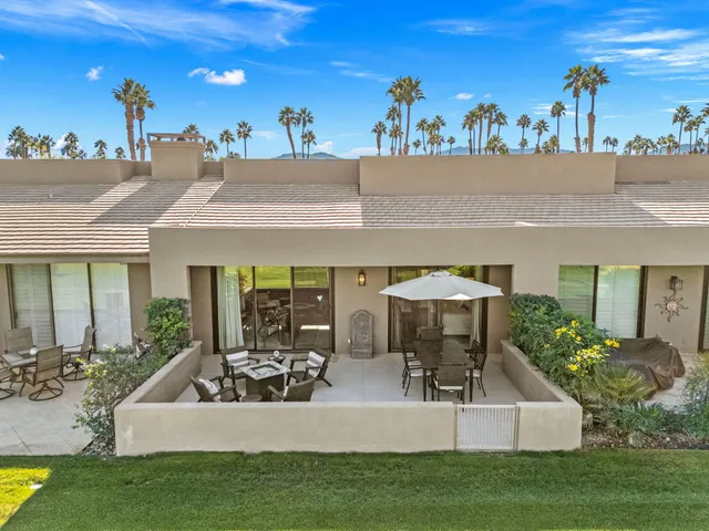 a living room with furniture fireplace and a large window