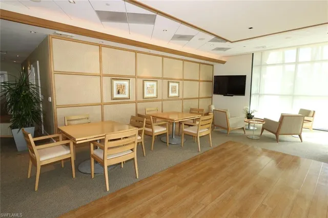 a outdoor space with a large window and sitting chairs