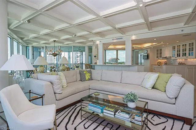 a living room with furniture and a chandelier