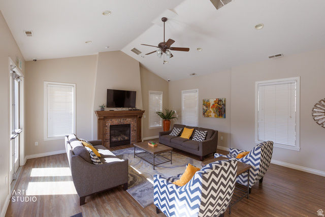 6761 950 East Midvale, UT 84047 - Photo 30 of 44 Community Clubhouse - Vaulted ceiling great room featuring a prominent fireplace with a wood mantle, wood-finish flooring, recessed lighting, and a ceiling fan