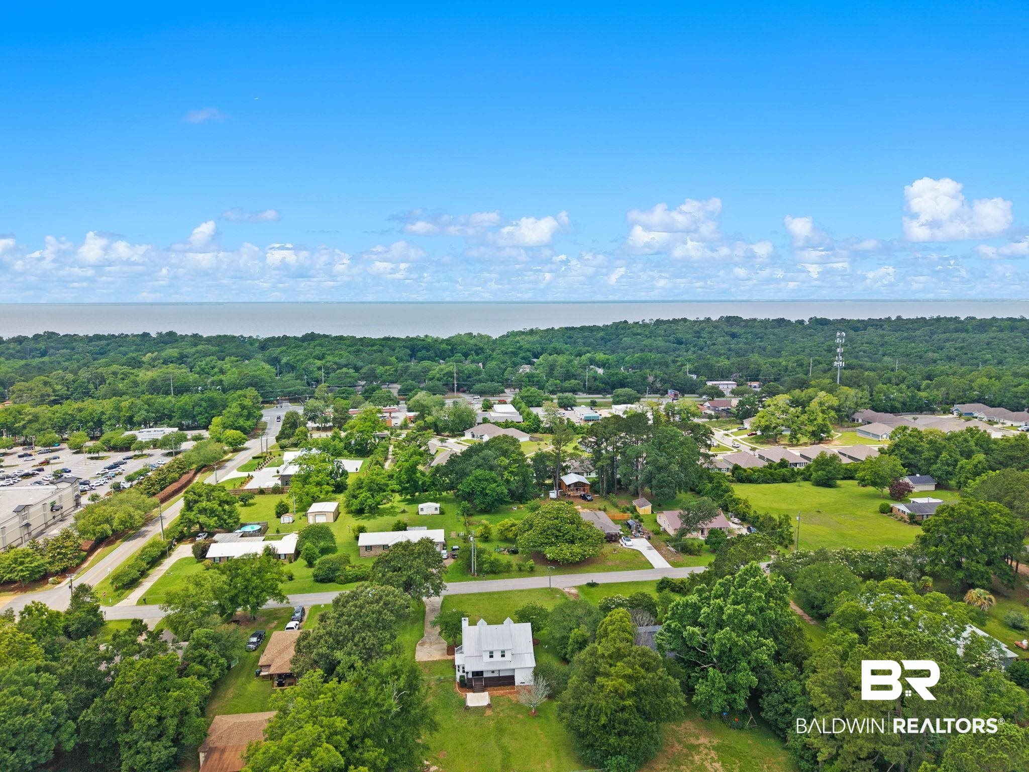 22810 High Ridge Road Fairhope, AL 36532 - Photo 76 of 78 Aerial perspective showcasing the residential area with abundant green space and a body of water on the horizon