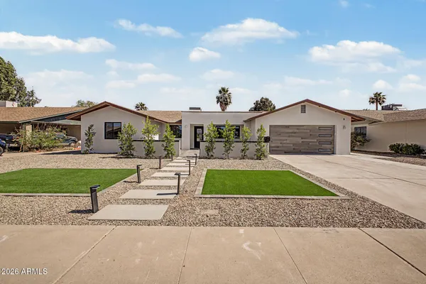 a front view of a house with a yard and garage
