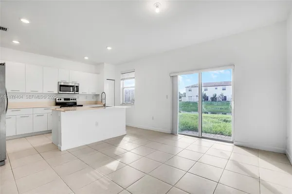 a kitchen with cabinets and appliances